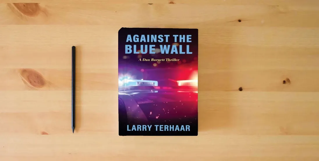 The book AGAINST THE BLUE WALL: A Dan Burnett Thriller} is on the table