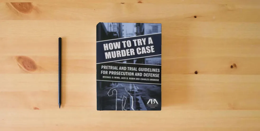 The book How to Try a Murder Case: Pretrial and Trial Guidelines for Prosecution and Defense} is on the table