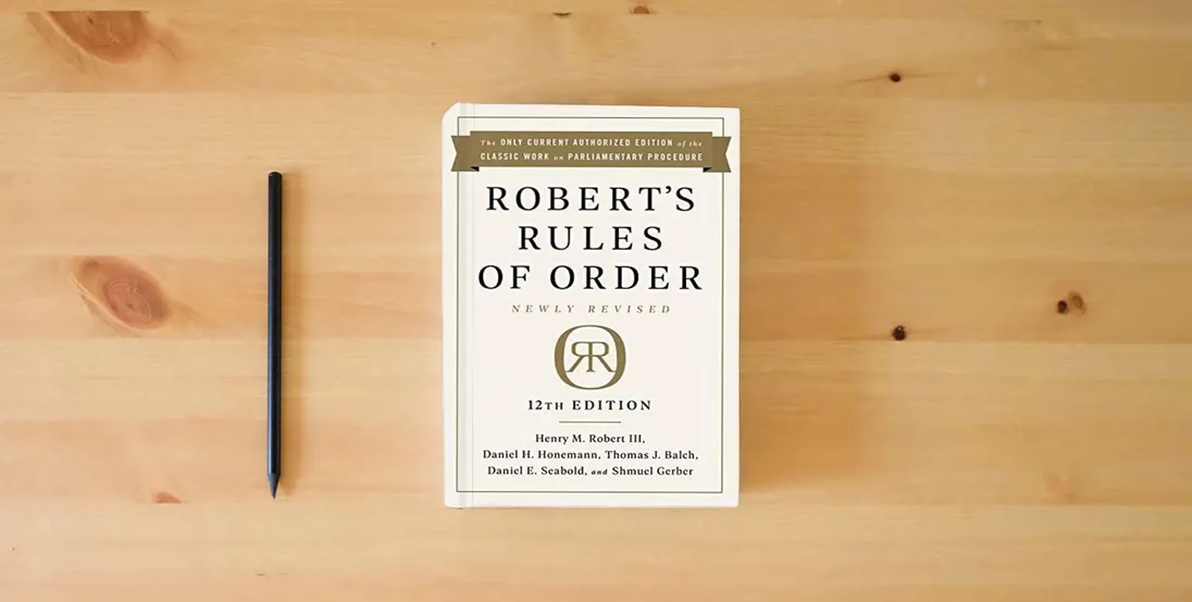 The book Robert's Rules of Order Newly Revised, 12th edition} is on the table